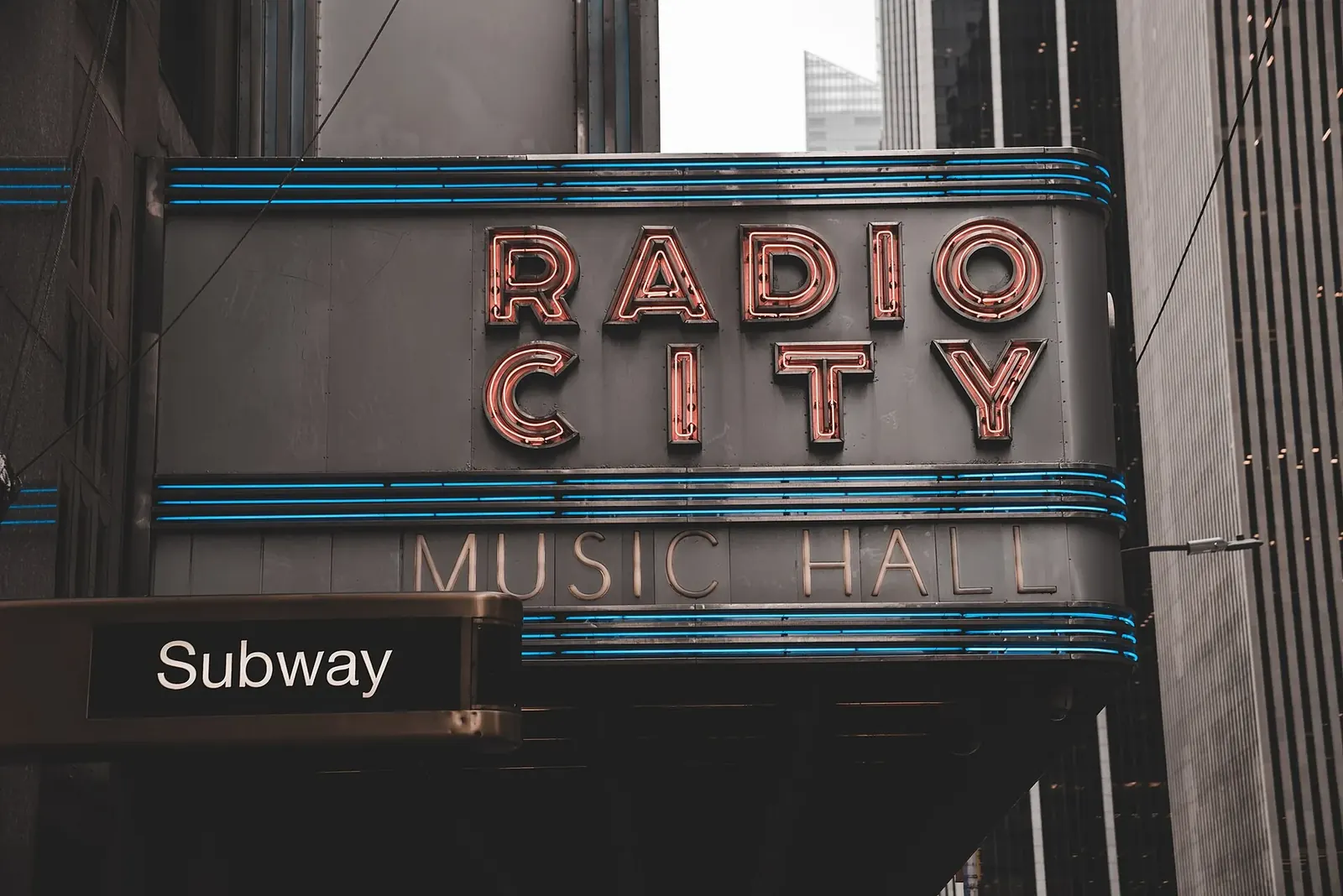 Neon signage above a Manhattan street at dusk