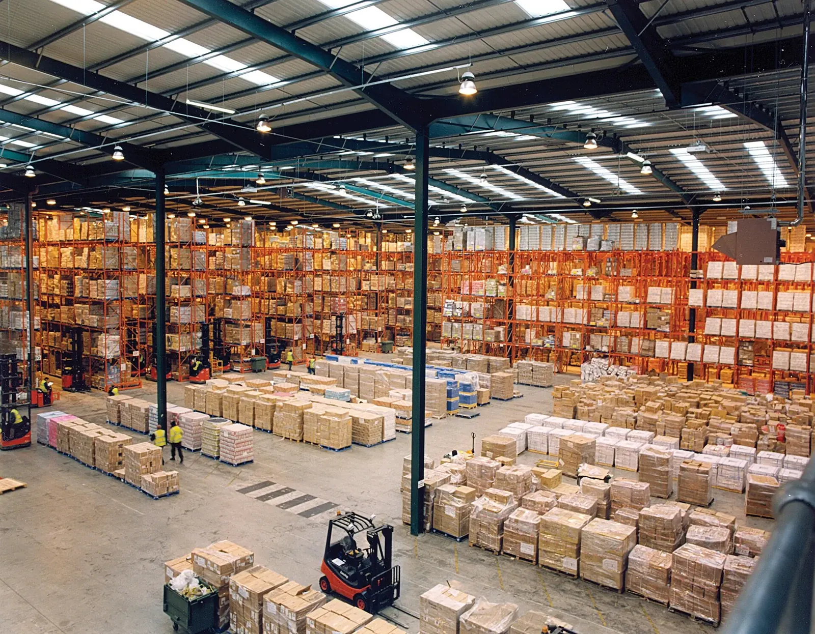 Pallet racking stacked with boxed goods inside a distribution warehouse